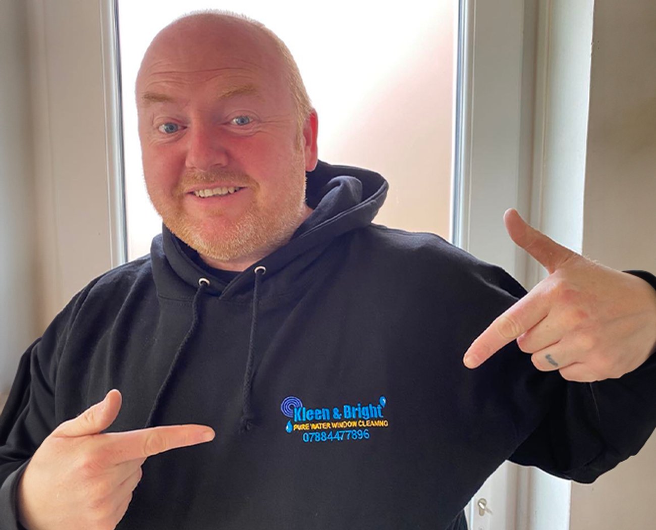 Friendly Team Member Wearing Branded Hoodie